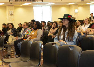 Medium shot of audience smiling and enjoying themselves watching a presenter at the 2025 Early Childhood Summit.