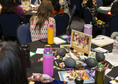 Close up of an audience table showing crayons, coloring books, etc. at the Texas Play & Development Conference.
