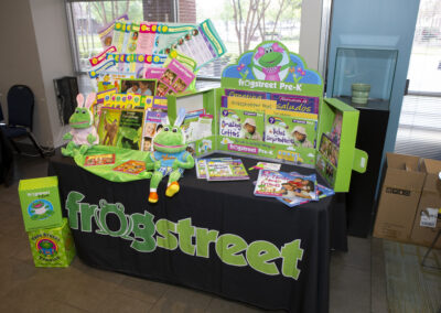 Booth labeled Frogstreet that has Frogstreet books, stuffed animals, etc.